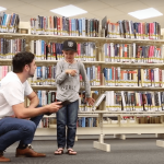 Hugo with a child at the Library