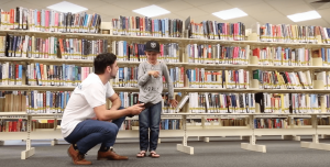 Hugo with a child at the Library